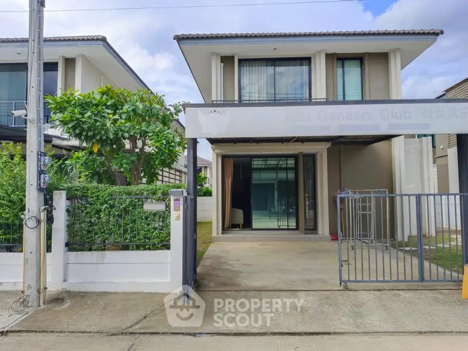 Modern two-story house with driveway and lush greenery in a serene neighborhood.
