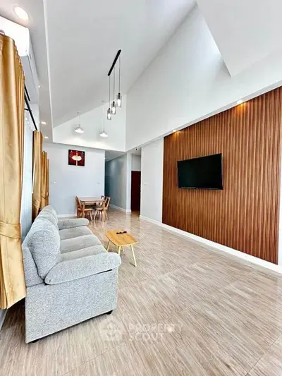 Spacious modern living room with high ceiling and elegant decor