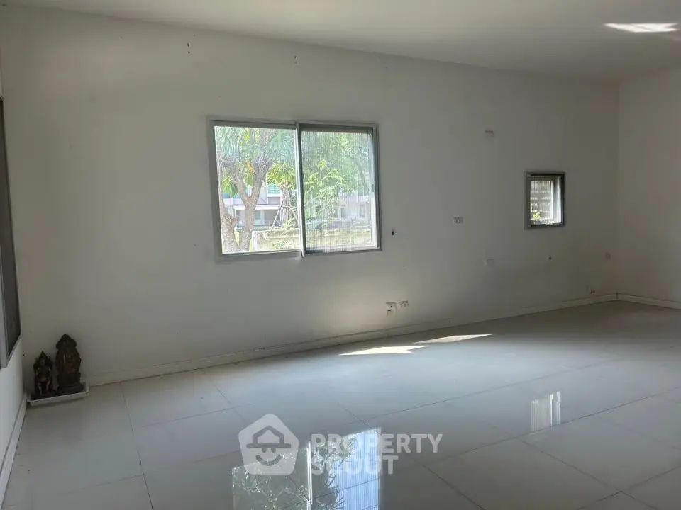 Spacious empty room with large windows and glossy tiled floor, perfect for customization.