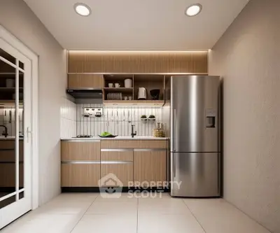 Modern kitchen with sleek cabinetry and stainless steel fridge in a compact layout.