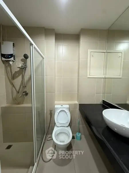 Modern bathroom with shower and sleek fixtures in a contemporary home.