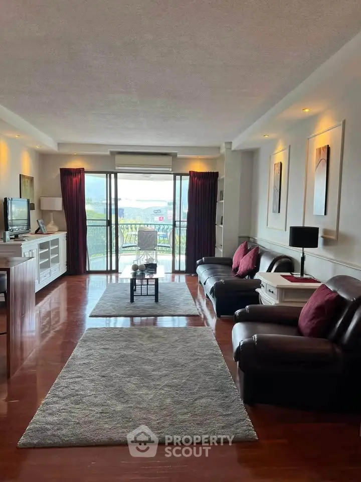 Spacious living room with elegant decor and balcony view