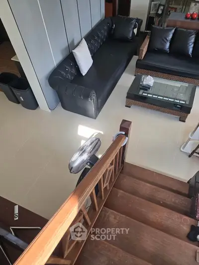 Stylish living room with modern furniture and elegant staircase