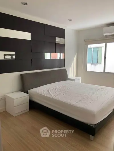 Modern bedroom with stylish headboard and natural light