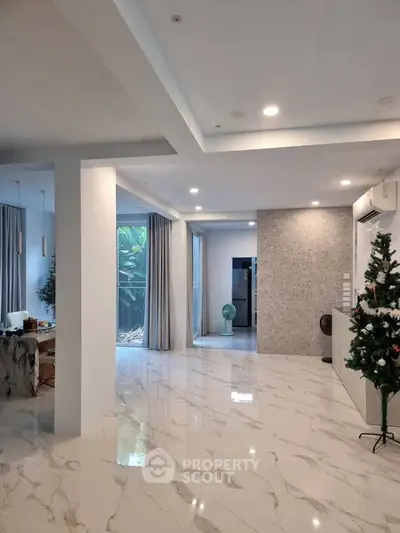 Spacious modern living area with marble flooring and elegant decor, perfect for luxury living.