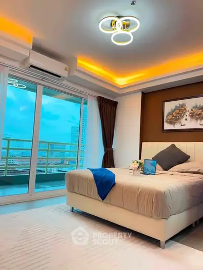 Luxurious bedroom with modern lighting and balcony view in high-rise apartment