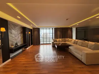 Luxurious living room with large sectional sofa and city view