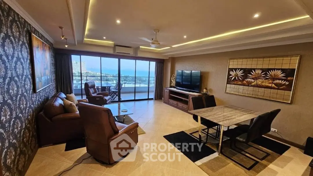 Spacious living room with modern decor and stunning sea view balcony.
