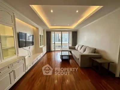 Spacious living room with elegant wooden flooring and modern lighting in a high-rise apartment.