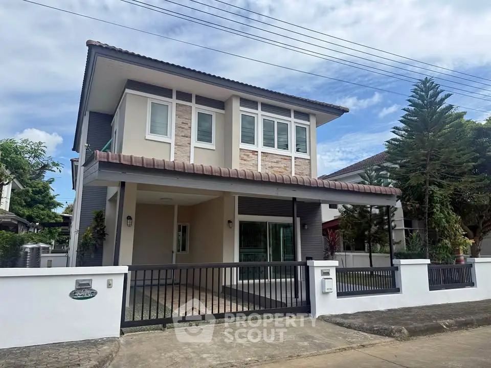 Charming two-story house with modern design and spacious front yard in a serene neighborhood.