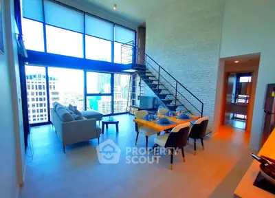 Stunning modern living room with high ceilings and city view, featuring elegant dining area and stylish staircase.