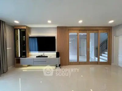 Modern living room with sleek entertainment center and elegant wood paneling