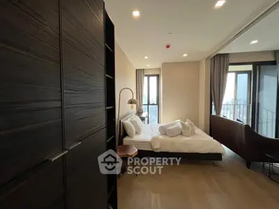 Modern bedroom with large windows and stylish decor in a high-rise apartment.