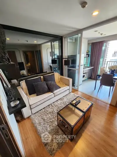 Modern living room with stylish decor and open layout leading to a balcony with city views.