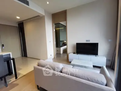 Modern living room with sleek furniture and open layout in a stylish apartment.
