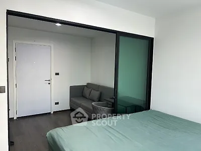 Modern bedroom with sliding glass door to cozy sitting area