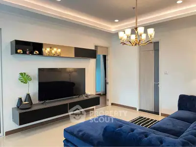 Modern living room with elegant lighting and plush blue sofa