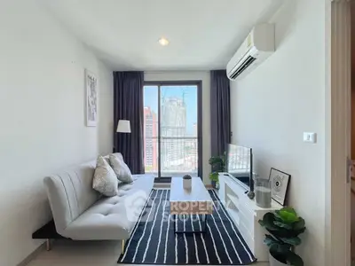 Modern living room with city view, stylish decor, and natural light.