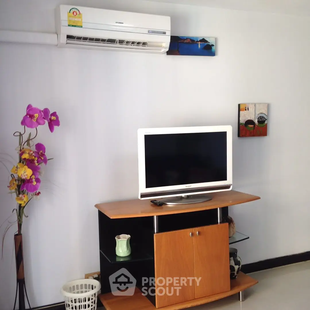 Modern living room with sleek TV stand and air conditioning unit
