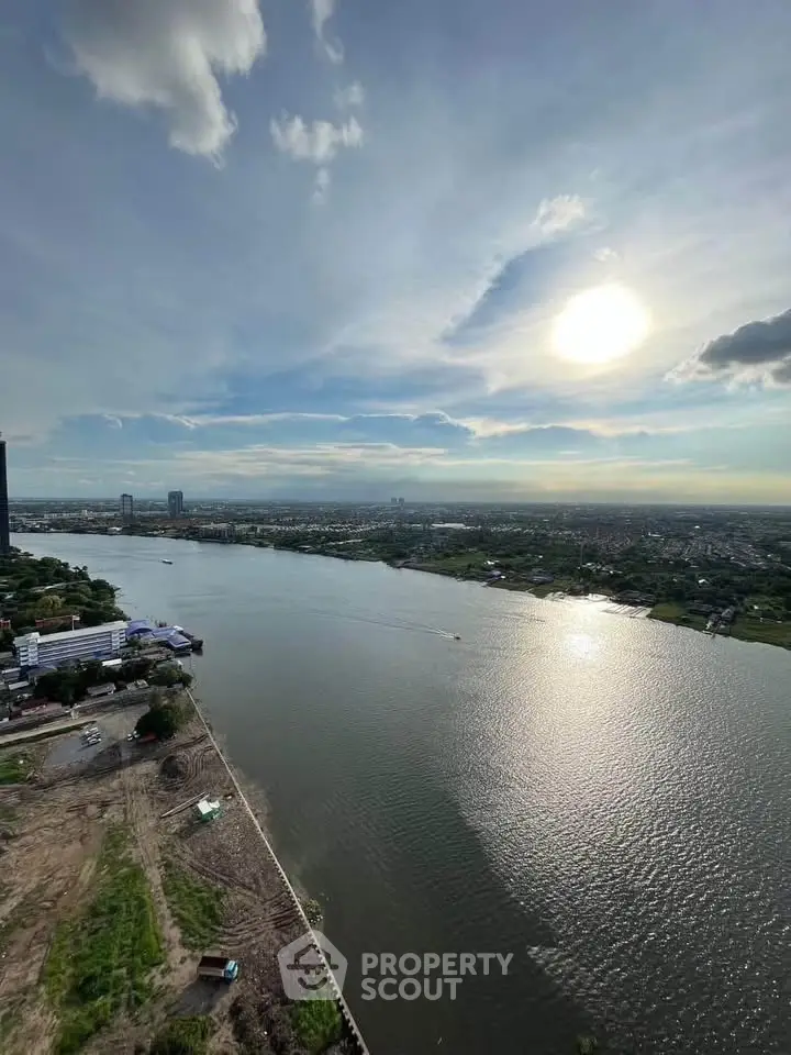 Stunning river view from high-rise building with expansive skyline and serene waters.