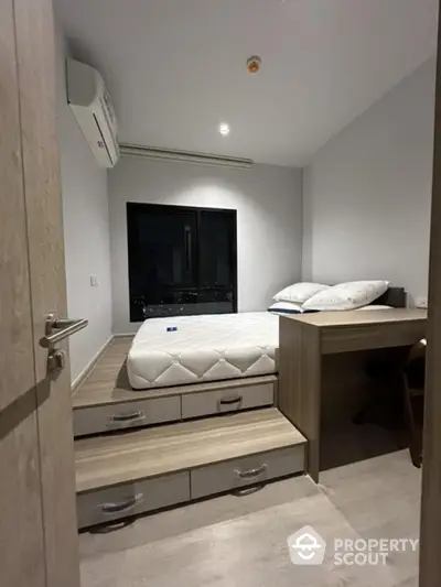 Modern compact bedroom with elevated bed and built-in storage drawers