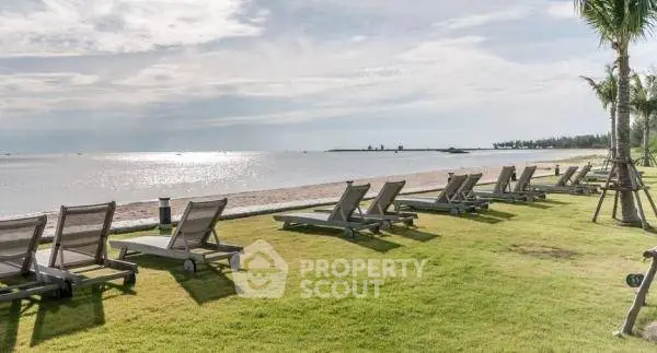 Beachfront property with lush green lawn and ocean view