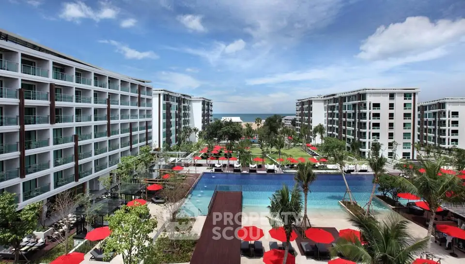 Luxurious beachfront resort with stunning pool and modern architecture, perfect for a tropical getaway.