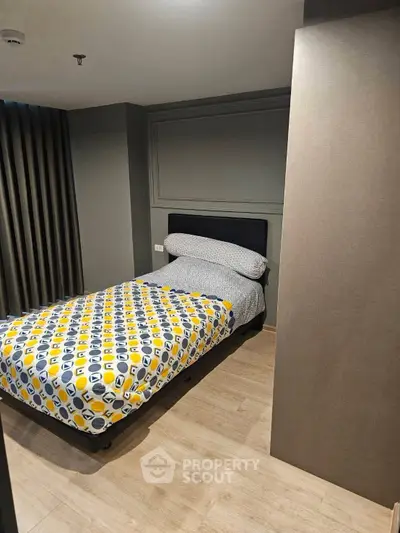 Cozy bedroom with modern decor and stylish bedding in a contemporary apartment.