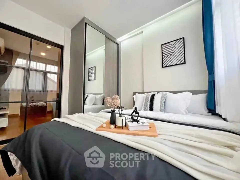 Modern bedroom with stylish decor and ample natural light