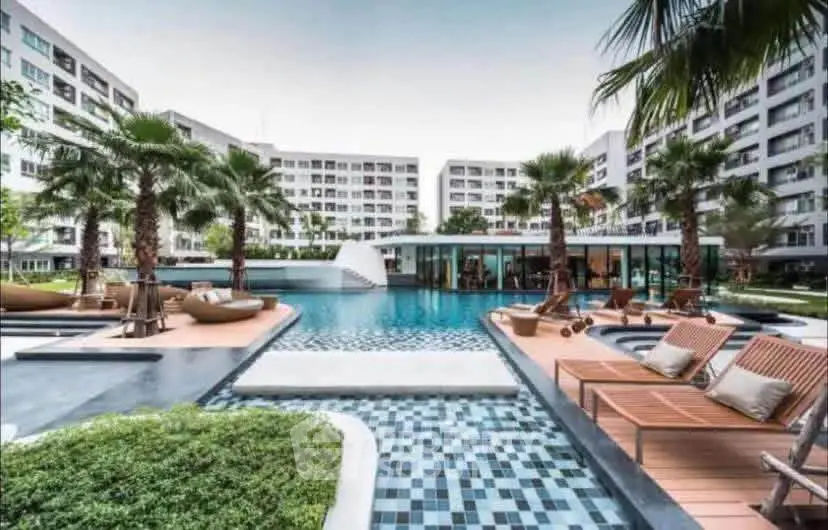 Luxurious condominium with stunning pool and lush landscaping, perfect for modern living.
