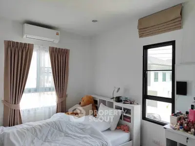Cozy bedroom with natural light, plush teddy bear, and modern decor