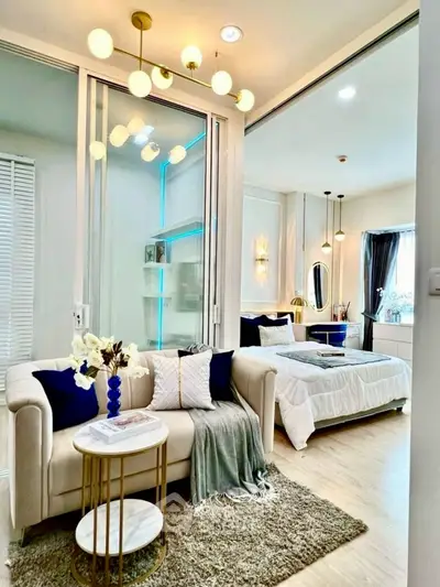 Modern open-plan living room and bedroom with elegant decor and soft lighting