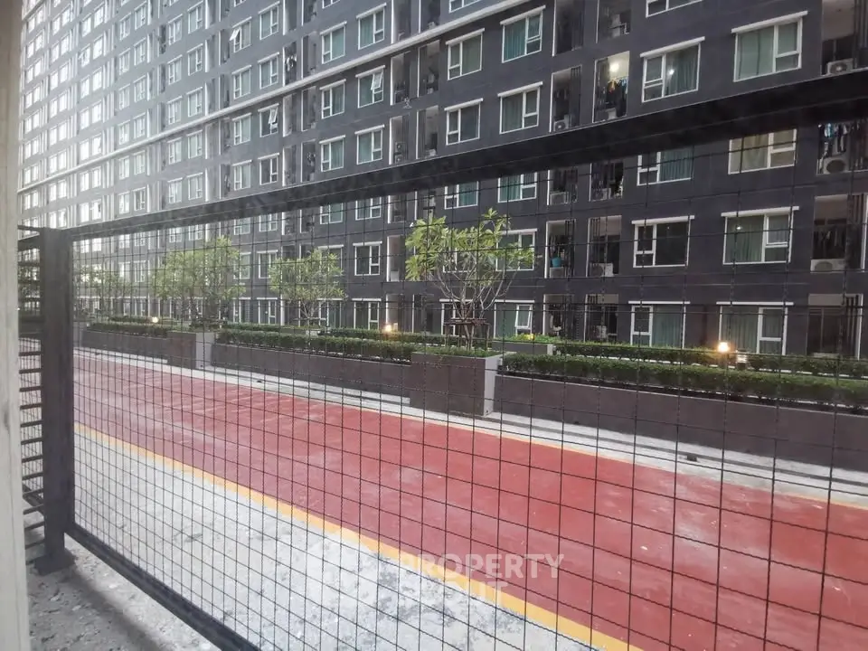 Modern apartment building with landscaped garden and secure fencing