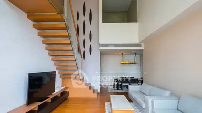 Modern duplex living room with wooden staircase and elegant decor