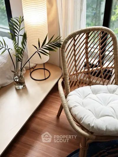 Cozy corner with rattan chair and soft lighting in modern apartment.