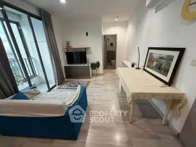Modern living room with balcony view, featuring stylish furniture and elegant decor.