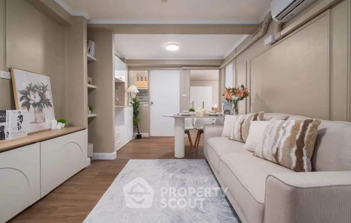 Stylish living room with modern decor and cozy seating in a contemporary apartment.