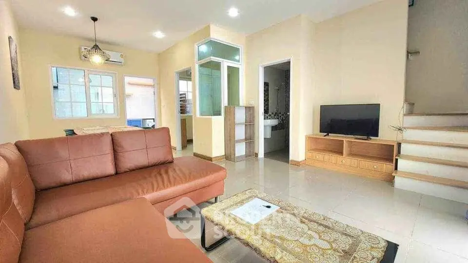 Spacious living room with modern furniture and natural lighting