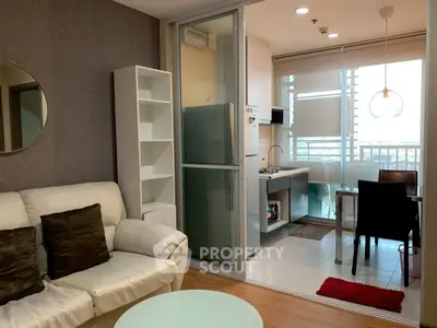 Modern living room with open kitchen and dining area, featuring sleek furniture and city view.