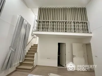 Modern duplex interior with high ceilings and mezzanine level