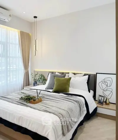 Modern bedroom with stylish decor and natural light