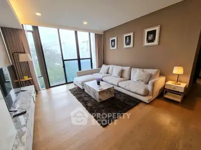 Spacious modern living room with large windows and stylish decor