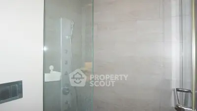 Modern bathroom with sleek glass shower enclosure and contemporary fixtures.