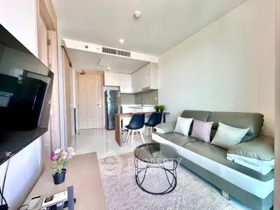 Modern living room with sleek furniture and open kitchen layout