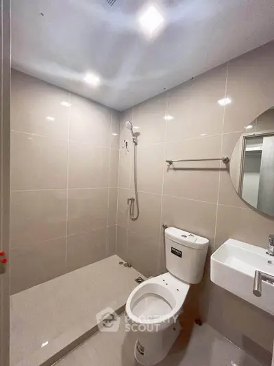 Modern bathroom with sleek tiles and contemporary fixtures in a stylish apartment.