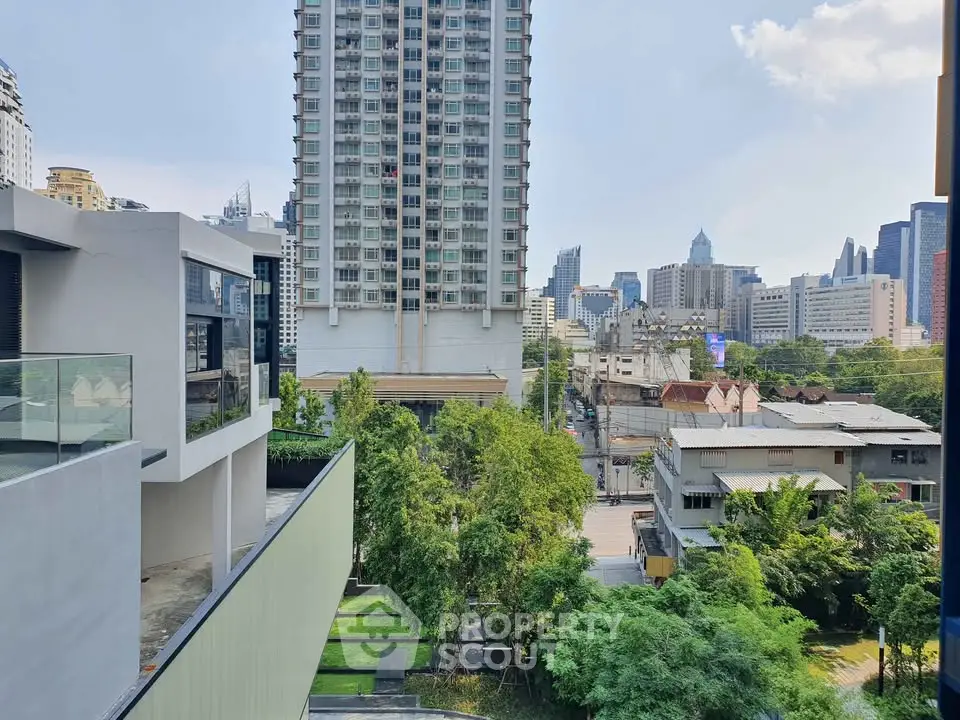 Stunning cityscape view from a modern apartment balcony, showcasing urban living with lush greenery and skyline.