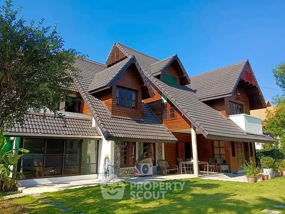 Charming wooden house with gabled roof and lush garden, perfect for serene living.
