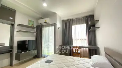 Modern bedroom with natural light, sleek furniture, and a cozy atmosphere perfect for relaxation.