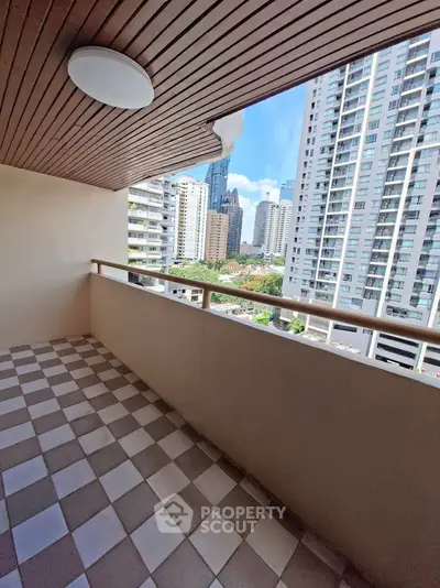 Spacious balcony with city view in modern high-rise apartment