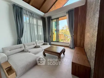 Luxurious living room with modern furniture and large windows offering natural light.